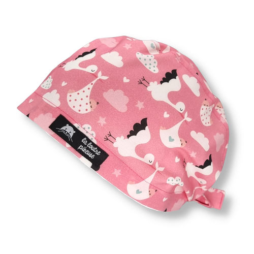 Calot de bloc couvrant - Cigognes Calot de bloc couvrant avec des cigognes apportant un bébé, rose
